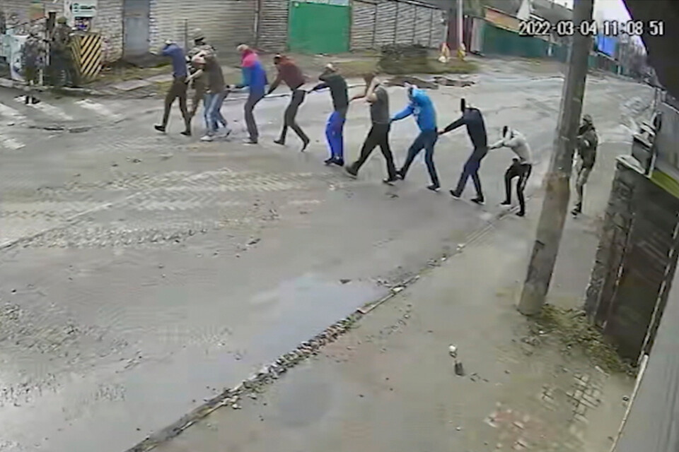 Stillbild från en övervakningskamera som visar hur tillfångatagna Butja-bor leds till ryssarnas improviserade maktbas på Jablunskagatan i Butja den 4 mars i år. De flesta kommer inte levande därifrån.