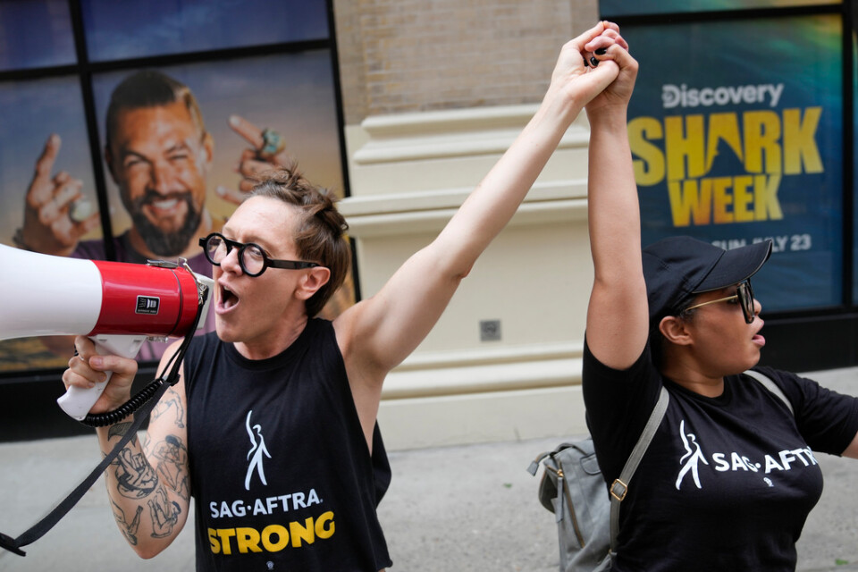 Strejkande manusförfattare och skådespelare sjunger ut sina protester i New York.