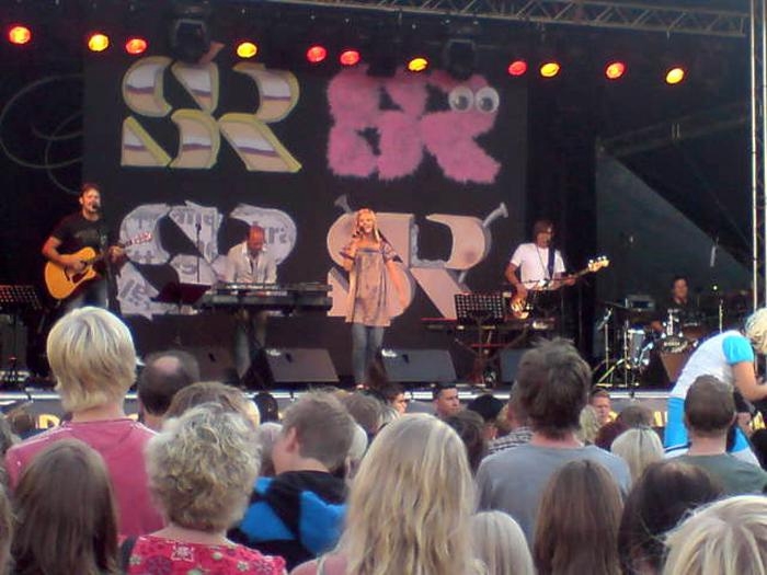 Jennifer Götvall värmer upp publiken med Ted Gärdestads låten vilken härlig dag.