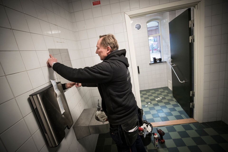 Glasmästare Stefan Nevhage byter en av de krossade speglarna på Centralstationens toalett.