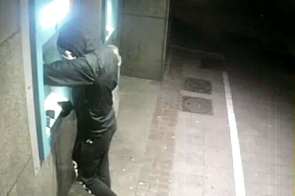 Rånare fångad av övervakningskamera när han tar ut pengar efter ett av rånen.
