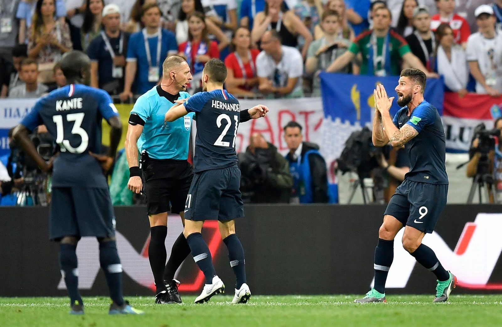 Referee Nestor Pitana from Argentina is surrounded by French players asking for a penalty during the final match between France and Croatia at the 2018 soccer World Cup in the Luzhniki Stadium in Moscow, Russia, Sunday, July 15, 2018. (AP Photo/Martin Meissner)