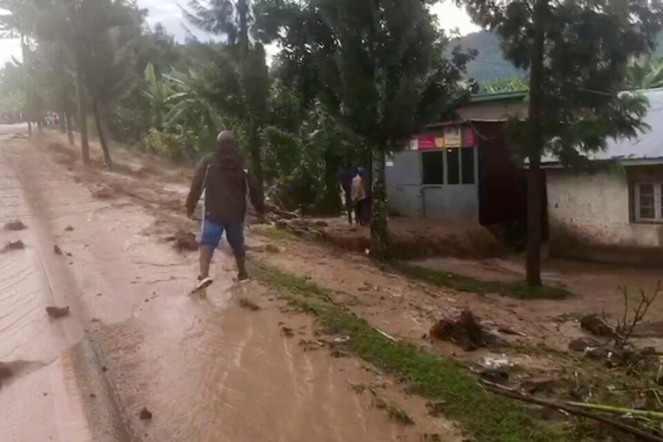 En man tar sig fram genom översvämningsvatten i västra Rwanda på tisdagen.