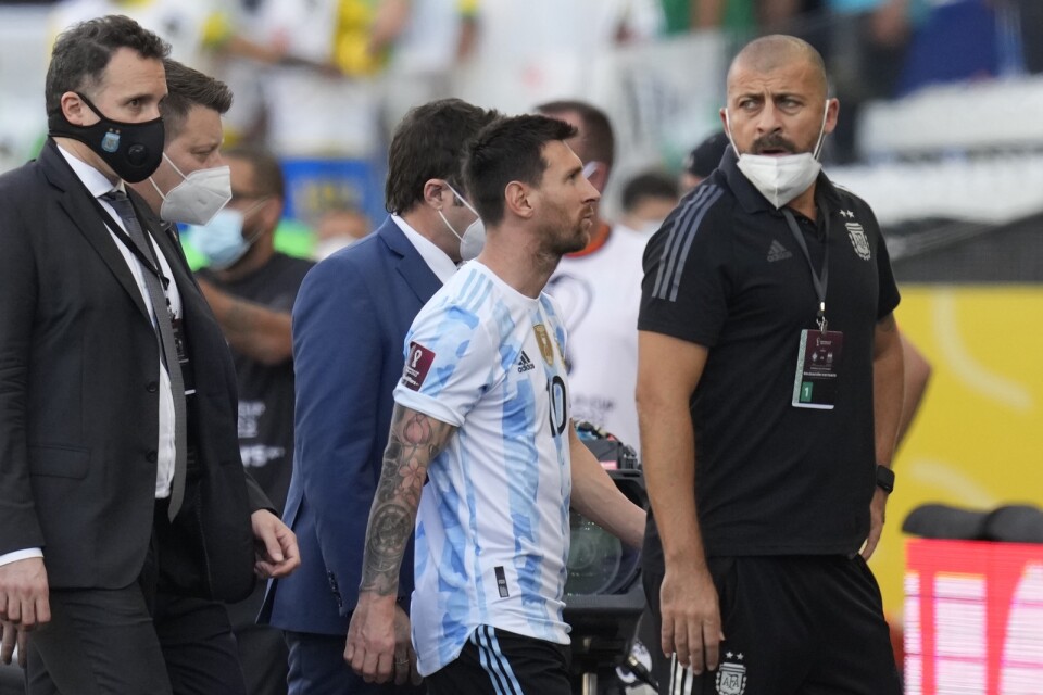 Lionel Messi lämnar planen efter en avbrutna matchen mot Brasilien.