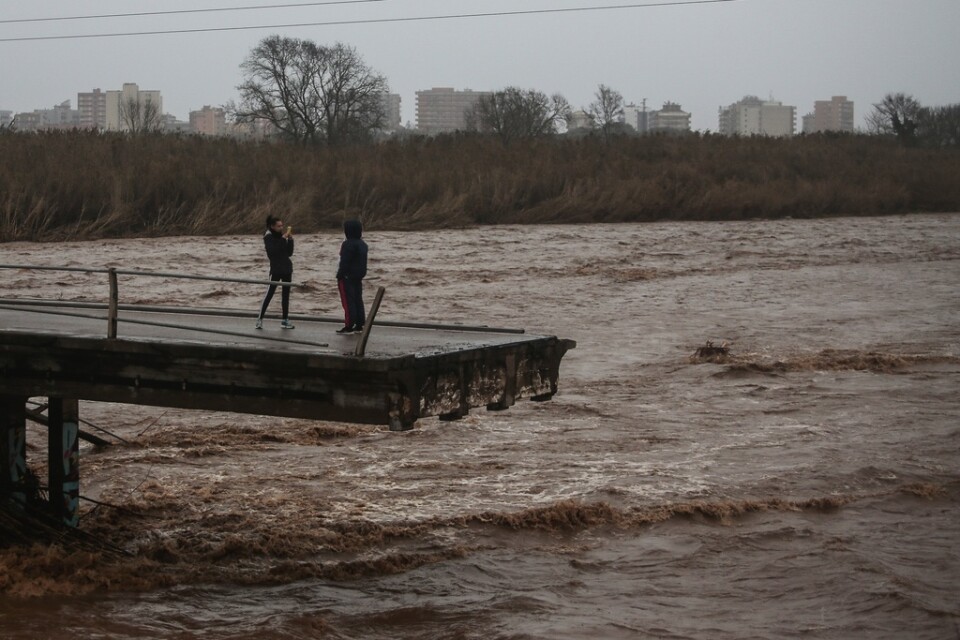 Två personer tar bilder från en bro som kollapsat i Malgrat, nära Barcelona. Bild tagen den 22 januari.