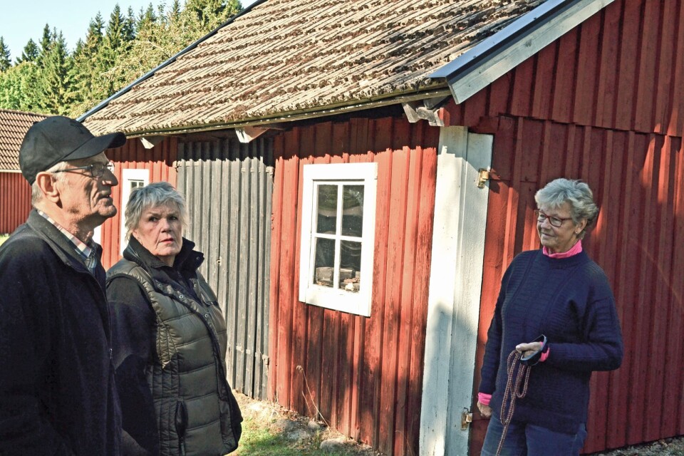 Historieguiden Ingvar Karlsson vid smedens verkstad. Här tillsammans med grannarna Lena Strand Petersson och Birgitta Fransson, kvinnorna som fick bygdens folk på benen när det vankades kulturminne.