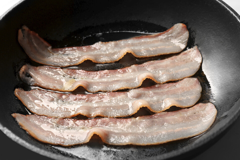 Dyrare bacon ligger i farans riktning. Arkivbild