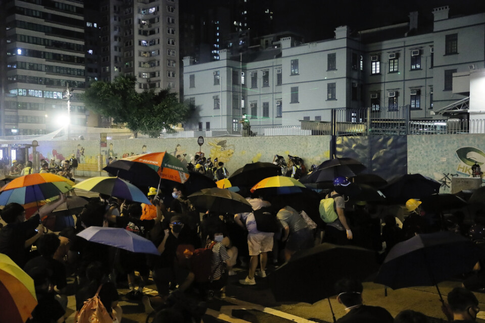 Poliser skjuter tårgas mot aktivister i Hongkong på fredagskvällen.