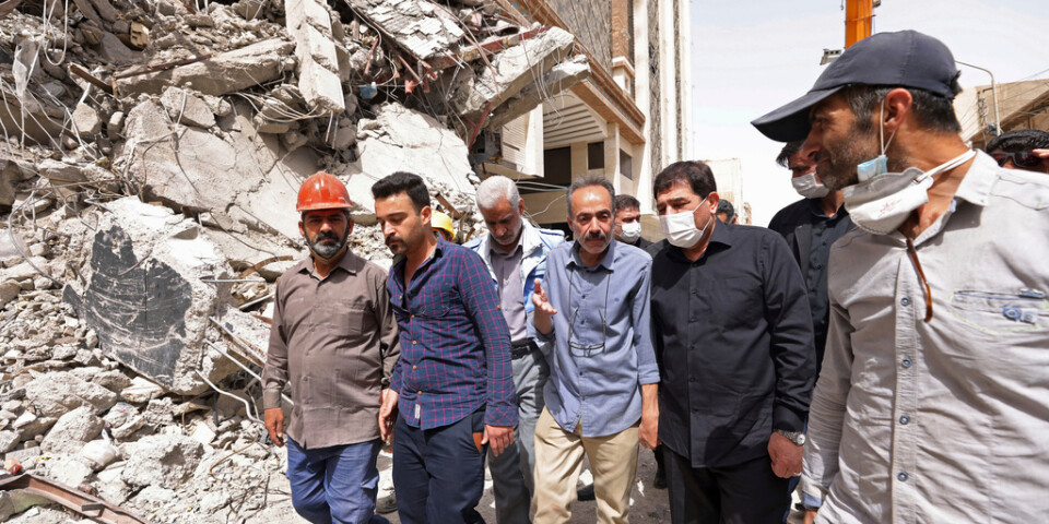 Myndighetspersoner, däribland vicepresident Mohammad Mokhber (andra personen från höger) inspekterar husraset i Abadan i Iran.