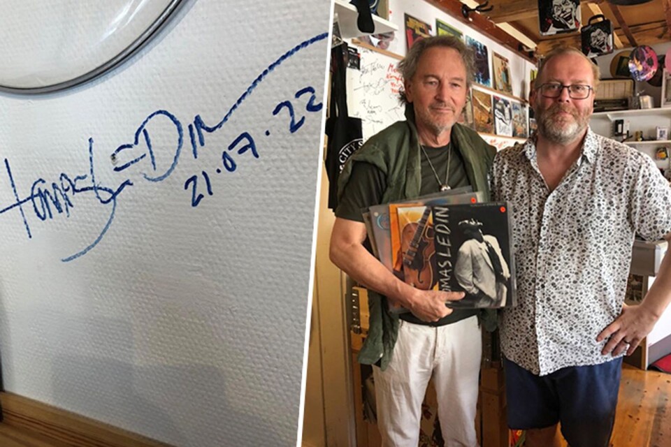 Tomas Ledin, med sina nyinköpta skivor, bredvid Janne Forslund. Han passade även på att signera väggen i butiken.