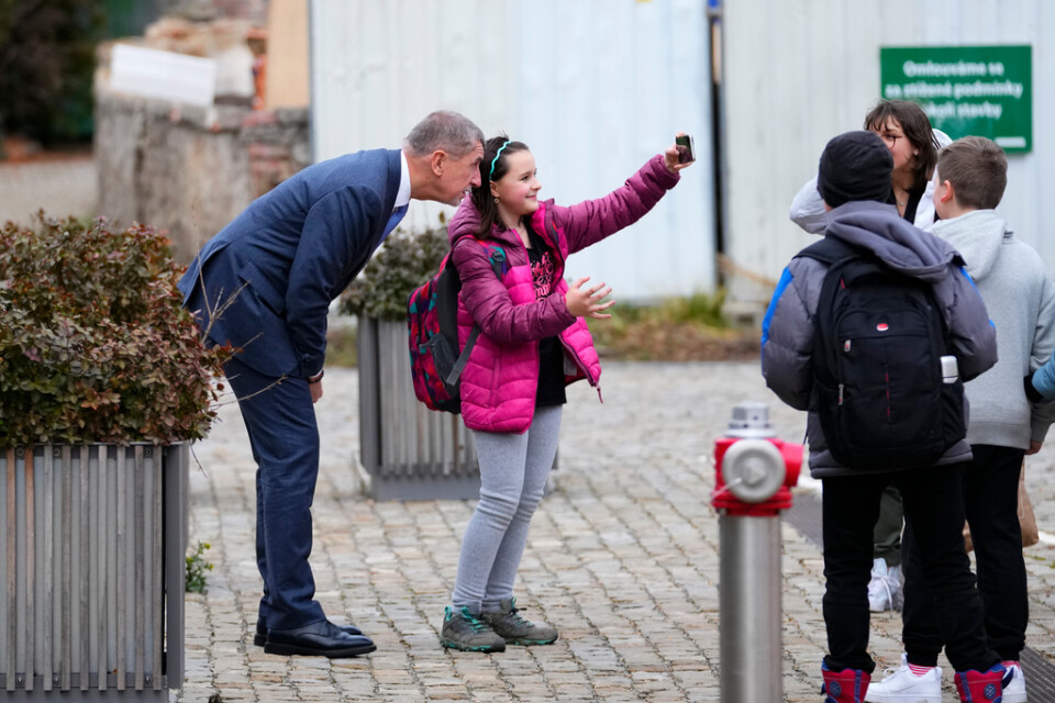En ung flicka fotograferar sig med förre premiärministern Andrej Babis under den första valomgången i Tjeckien den 13 januari. Arkivbild.