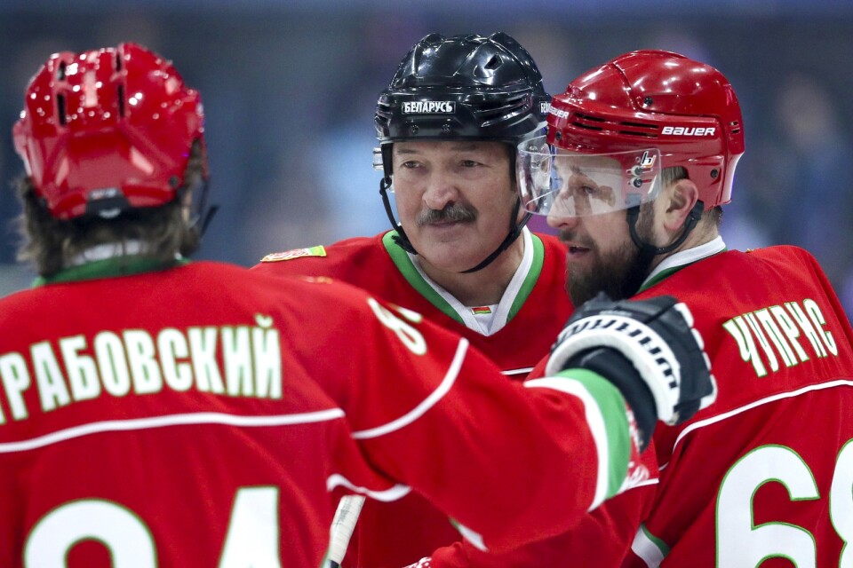 Belarus president Aleksandr Lukasjenko, mitten, har haft en vän i hockeyordföranden Dmitrij Baskov. Men nu stängs Baskov av från all ishockey i fem år, uppger Internationella ishockeyförbundet. Arkivbild.