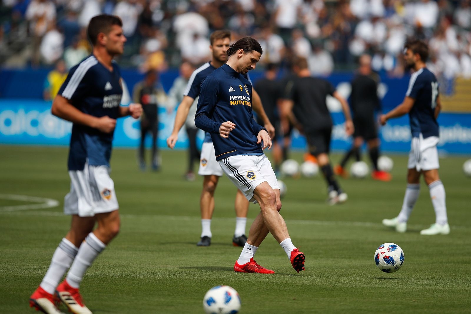 Los Angeles Galaxy's Zlatan Ibrahimovic, center, of Sweden, warms up before the team's MLS soccer match against the Los Angeles FC, Saturday, March 31, 2018, in Carson, Calif. (AP Photo/Jae C. Hong)