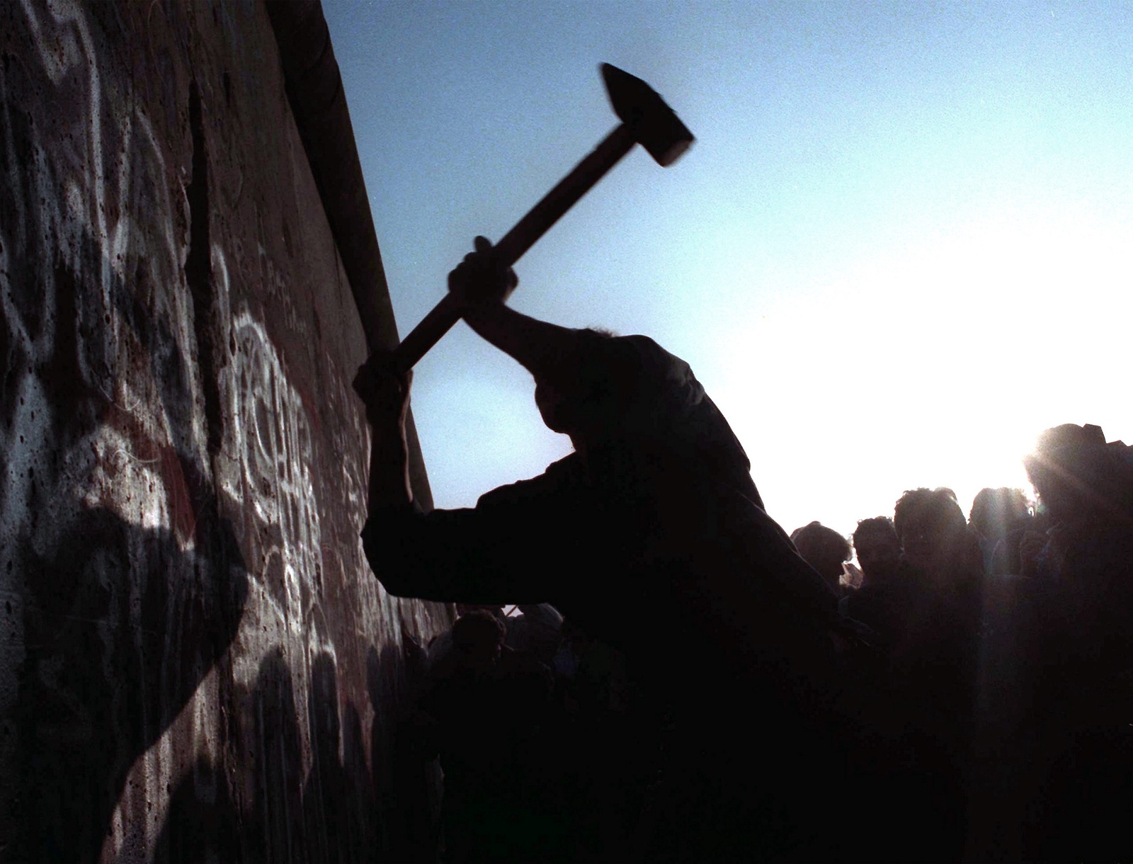 FILE - This Nov. 12, 1989 file photo shows a man hammering at the Berlin Wall, as the border barrier between East and West Germany was torn down after 28 years. Monday, Nov. 9, 2009 marks the 20th anniversary of the fall of the Berlin Wall. (AP Photo/John Gaps III, File)