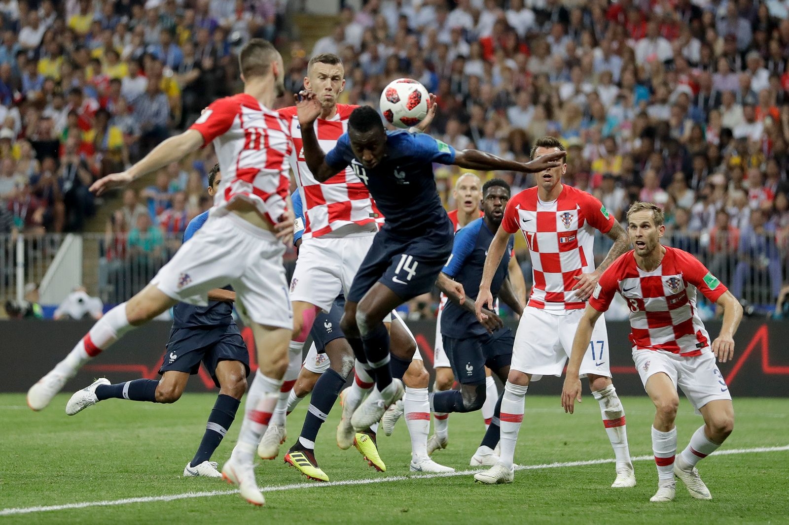 Croatia's Ivan Perisic, second left, touches the ball with his hand as he jumps for the ball with France's Blaise Matuidi during the final match between France and Croatia at the 2018 soccer World Cup in the Luzhniki Stadium in Moscow, Russia, Sunday, July 15, 2018. (AP Photo/Matthias Schrader)