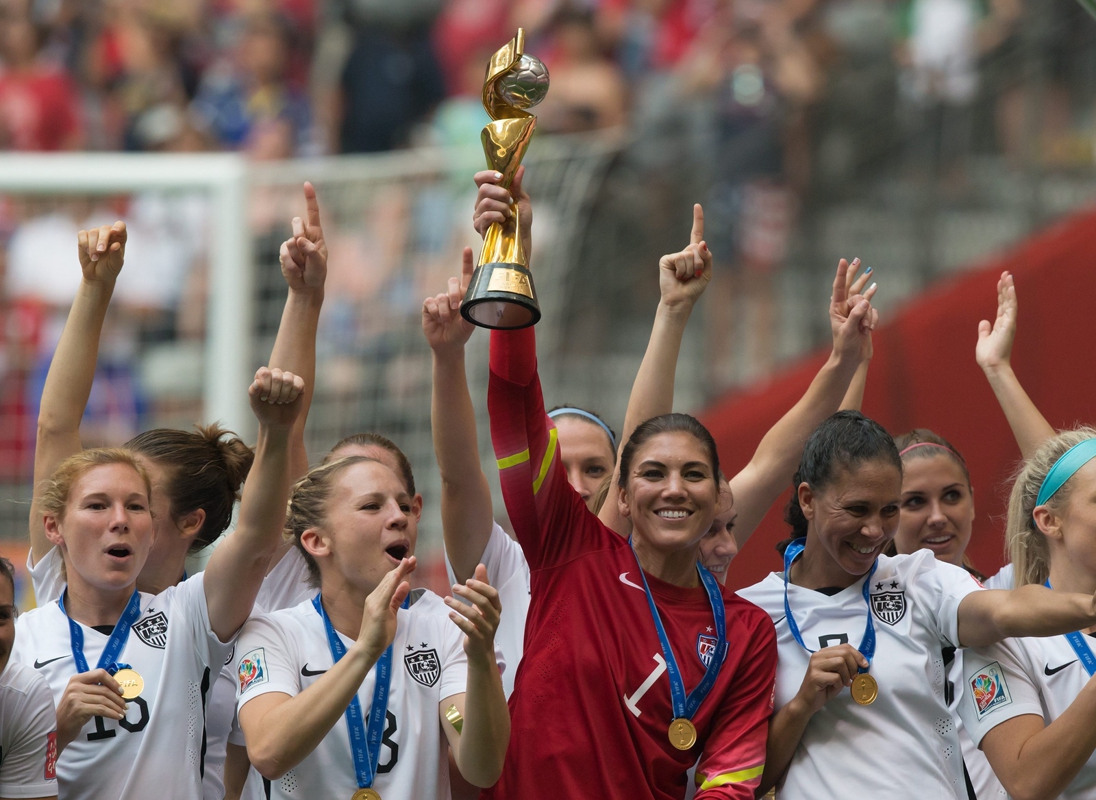 United States goalkeeper Hope Solo hoists the trophy as she and her teammates celebrate defeating Japan to win the FIFA Women's World Cup soccer championship in Vancouver, British Columbia, Canada, Sunday, July 5, 2015.   (Darryl Dyck/The Canadian Press via AP) MANDATORY CREDIT