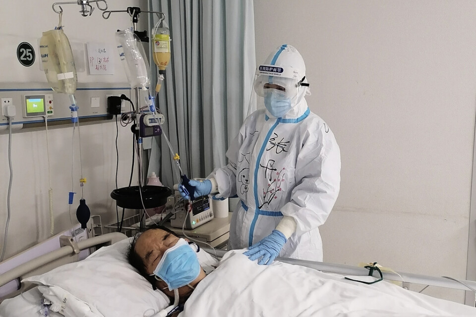 En sjuksköterska vårdar en covidpatient på Tongjisjukhuset i Wuhan. Arkivbild.