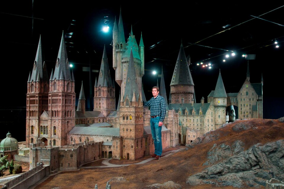 Jose Granell, model supervisor, unveils a model of Hogwarts castle at the Warner Bros Studio Tour, Watford, London, Thursday, March 1, 2012. The Hogwarts castle model was built for the first film 'Harry Potter and the Philosopher's Stone', it was created for aerial photography and was digitally scanned for CGI scenes. It took 86 artists and crew members to construct, it measures over 50 feet in diameter and has over 2,500 fibre optic lights.  (AP Photo/Jonathan Short)