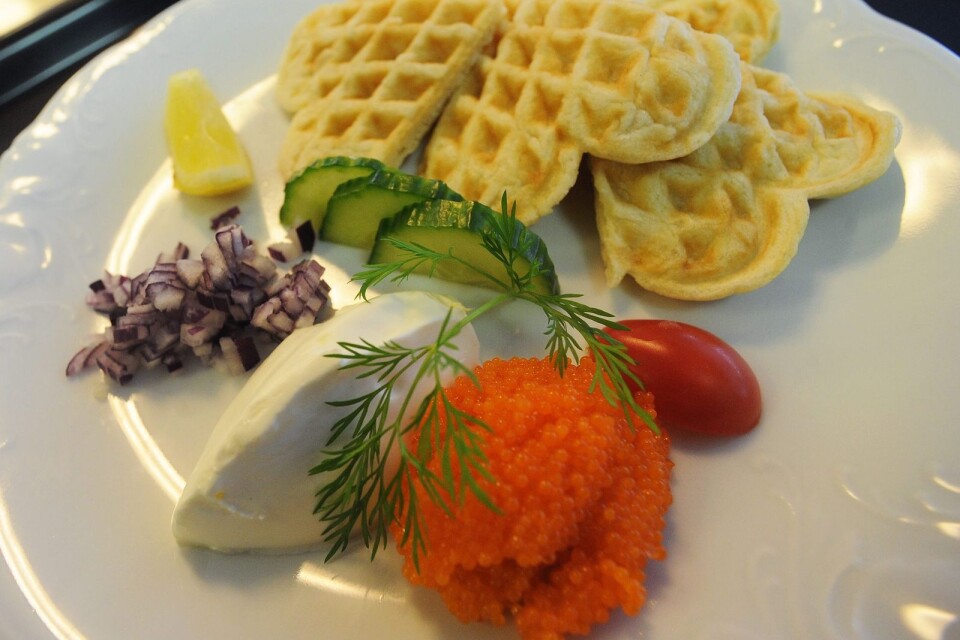Waffles with roe, onion and sour cream.