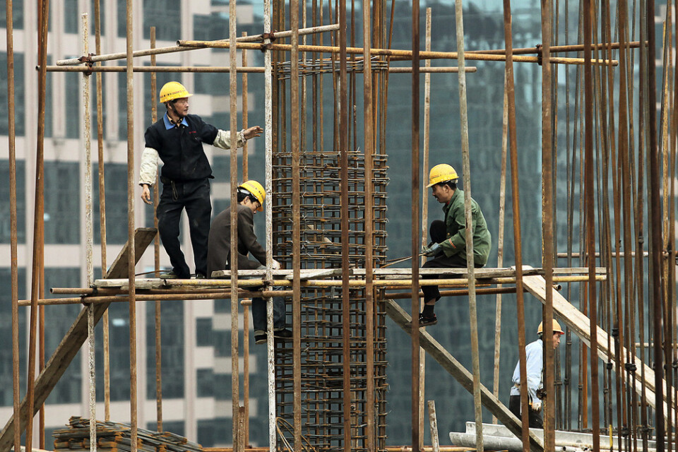 Byggnadsarbetare i Shanghai, Kina. Arkivbild.