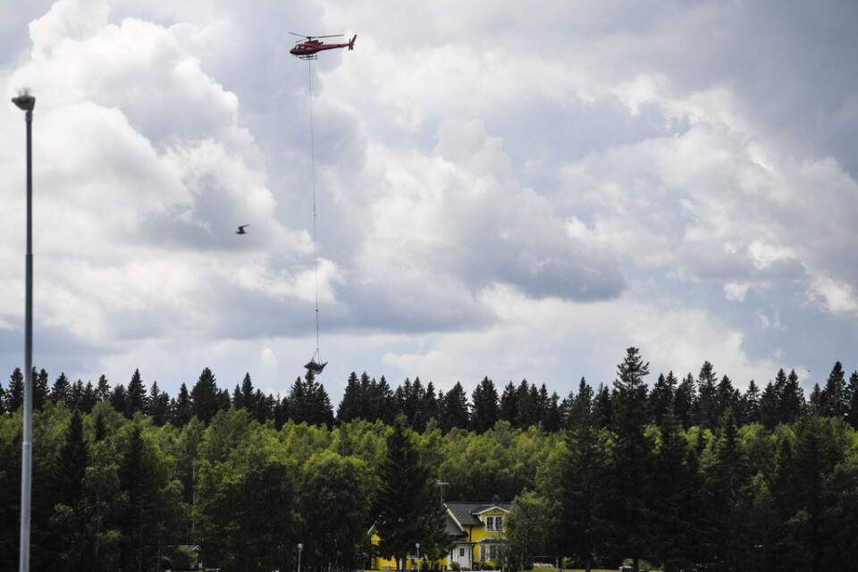 En helikopter bärgar vrakdelar från flygplanet som kraschade på ön Storsandskär utanför Umeå den 14 juli 2019. Arkivbild.