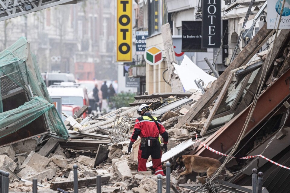Räddningspersonal söker i bråten efter den förstörda byggnaden i Lille på lördagen.