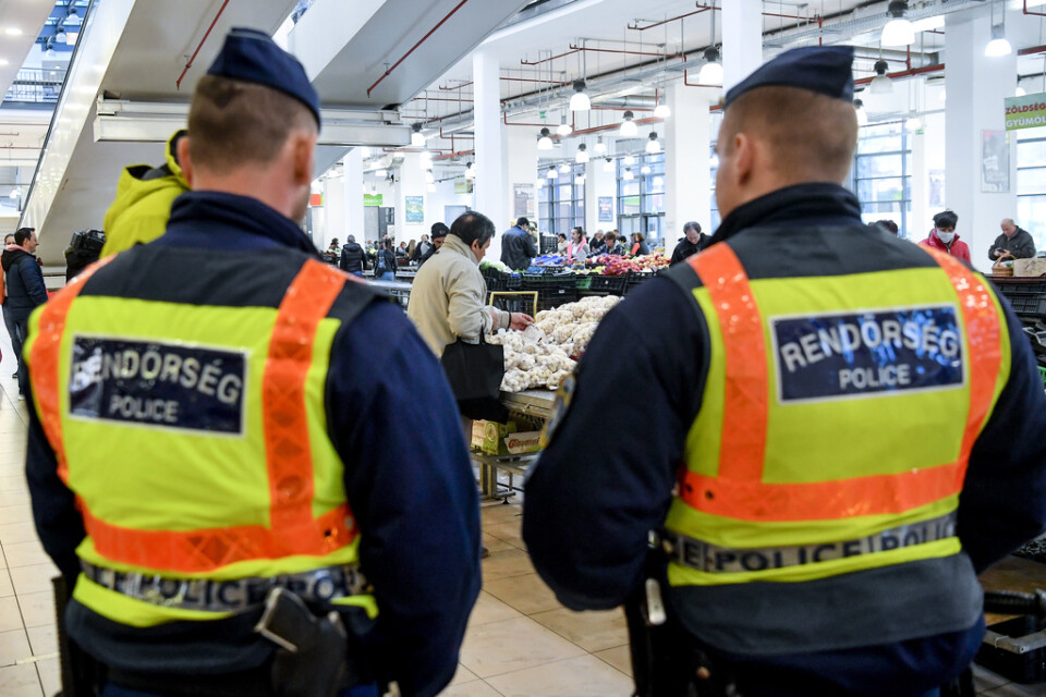 Ungerska poliser håller koll på att coronarestriktionerna följs på en marknad i Debrecen. Arkivbild.