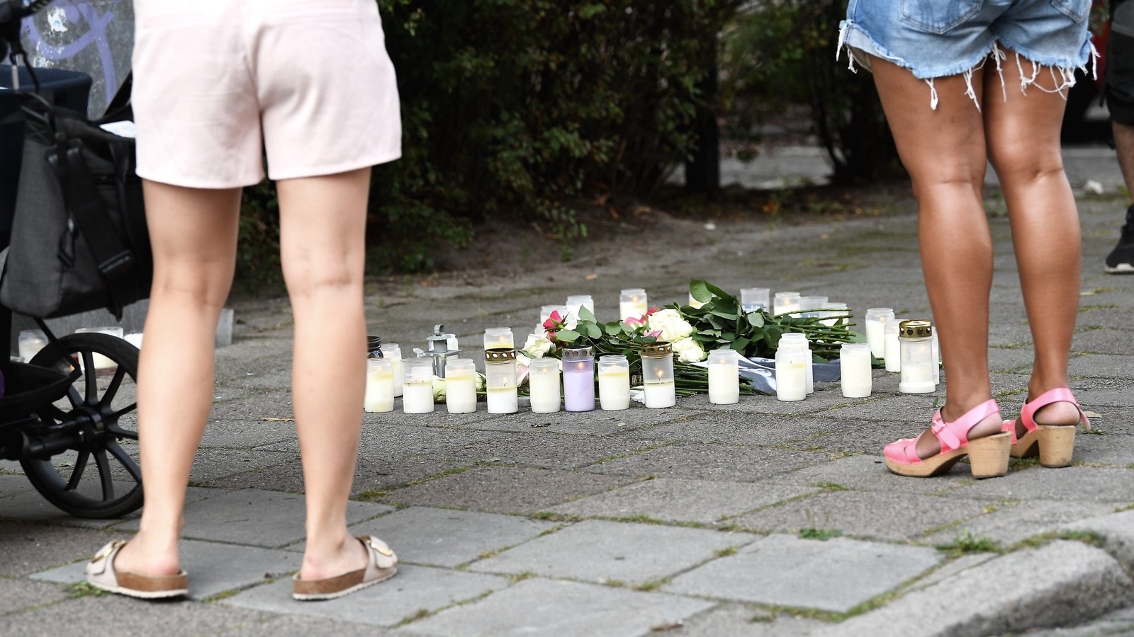 Blommor och ljus på platsen där en 30-årig kvinna sköts till döds på öppen gatan i stadsdelen Ribersborg i Malmö. Foto: Johan Nilsson/TT