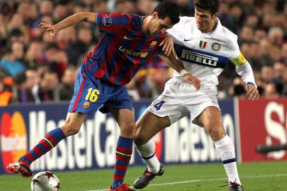 FC Barcelona&apos;s Sergio Busquets, till vänster och Inter Milan&apos;s Javier Zanetti kämpar om bollen i Champions League.