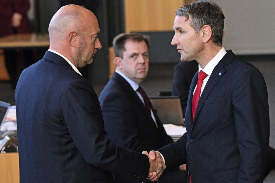 AFD:s Thüringenordförande Björn Höcke, till höger, skakar hand med liberala FDP:s Thomas Kemmerich efter att denne valts till ministerpresident i delstaten.