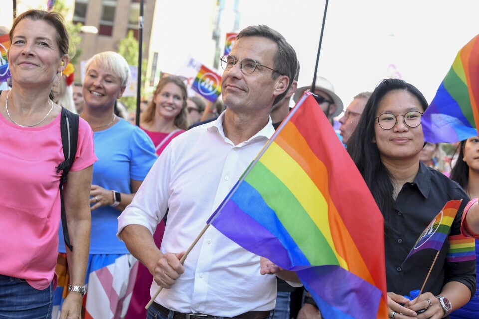 Statsminister Ulf Kristersson (M) under Prideparaden i Stockholm. Han har gjort sig känd för sina lyckade mingel, men ledarsidans Anela Murguz ser ett par fallgropar.