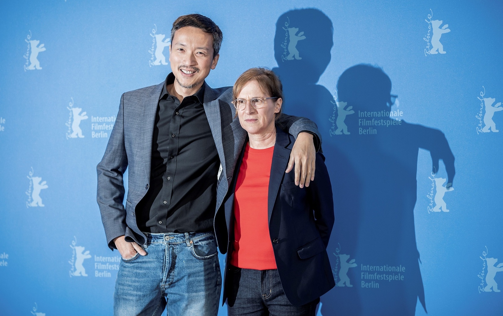 Actor Orion Lee, left, and director Kelly Reichardt, right, pose for photographers during a photo-call for the film 'First Cow' during the 70th International Film Festival Berlin, Berlinale, in Berlin, Germany, Saturday, Feb. 22, 2020. (Michael Kappeler/dpa via AP)  DMSC110