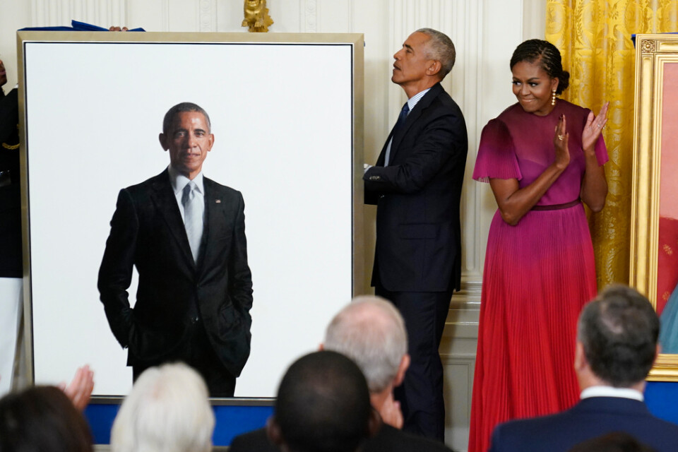 Michelle Obama ger maken Barack Obamas porträtt en applåd.