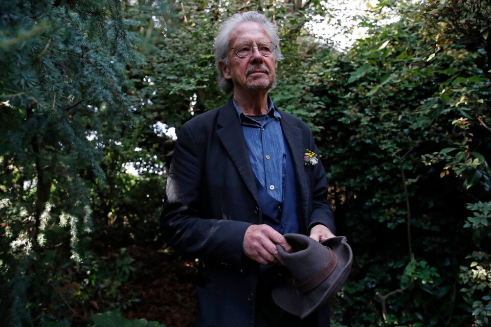 Austrian author Peter Handke poses for a photo in his garden at his house in Chaville near Paris, Thursday, Oct. 10, 2019. Handke was awarded the 2019 Nobel Prize in literature earlier Thursday. (AP Photo/Francois More)  TH103