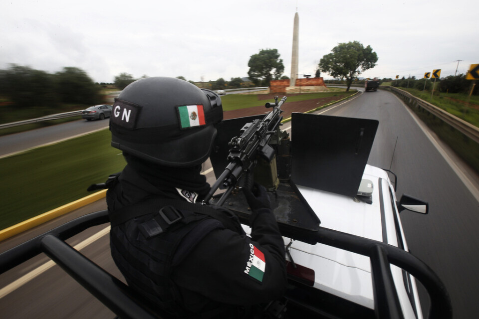 En soldat bevakar en motorväg i delstaten Zacatecas i centrala Mexiko efter en rad attacker från drogkarteller i juli. Arkivbild.
