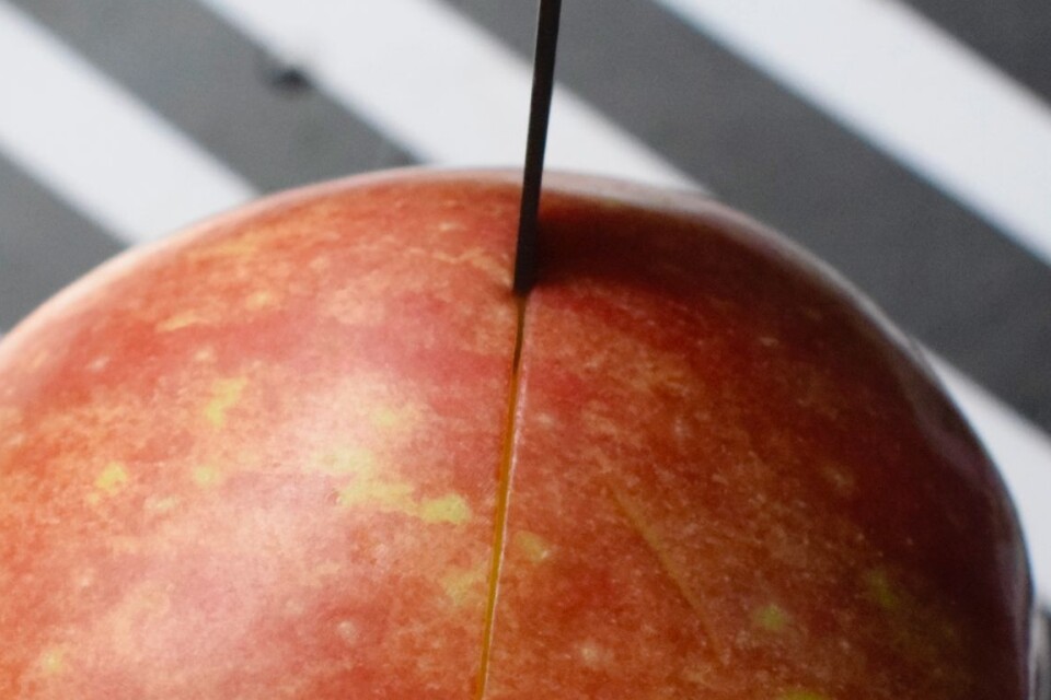 Make a score round the middle of the apple with a sharp knife to prevent the apple from exploding.