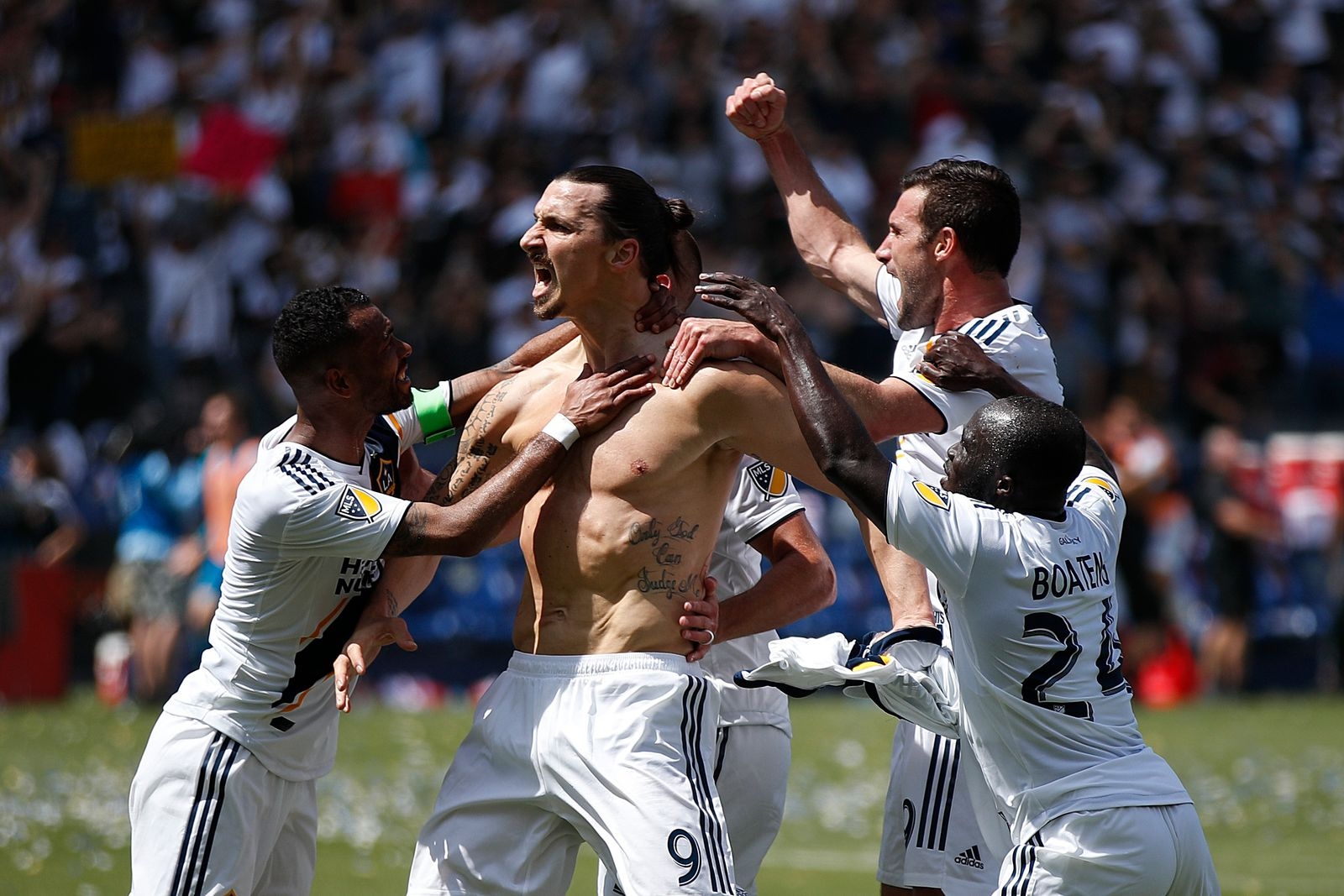 Los Angeles Galaxy's Zlatan Ibrahimovic, center, of Sweden, and teammates celebrate a goal by Ibrahimovic during the second half of an MLS soccer match against the Los Angeles FC Saturday, March 31, 2018, in Carson, Calif. The Galaxy won 4-3. (AP Photo/Jae C. Hong)