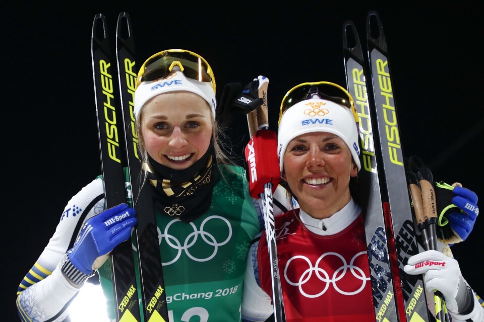 United States' Jessica Diggins, left, and Kikkan Randall pose after winning the gold medal in the women's team sprint freestyle cross-country skiing final at the 2018 Winter Olympics in Pyeongchang, South Korea, Wednesday, Feb. 21, 2018. (AP Photo/Matthias Schrader)
