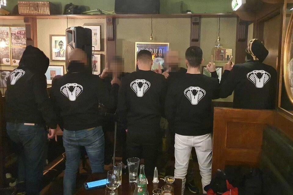 Members wearing the gang's black sweatshirt with a white cobra at a meeting in the premises at Vilan.