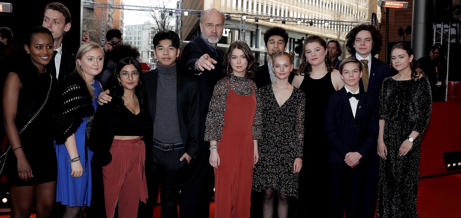 The cast of the film "Utoya 22. Juli" ( U - July 22) with director Erik Poppe, center, and actress Andrea Berntzen, center right in red, arrive for the screening of the film during the 68th edition of the International Film Festival Berlin, Berlinale, in Berlin, Germany, Monday, Feb. 19, 2018. (AP Photo/Markus Schreiber)