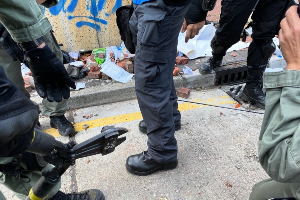 I en bild som släppts från polismyndigheten i Hongkong förbereder sig polisen för att ta bort en pil som träffat en polisanställd.