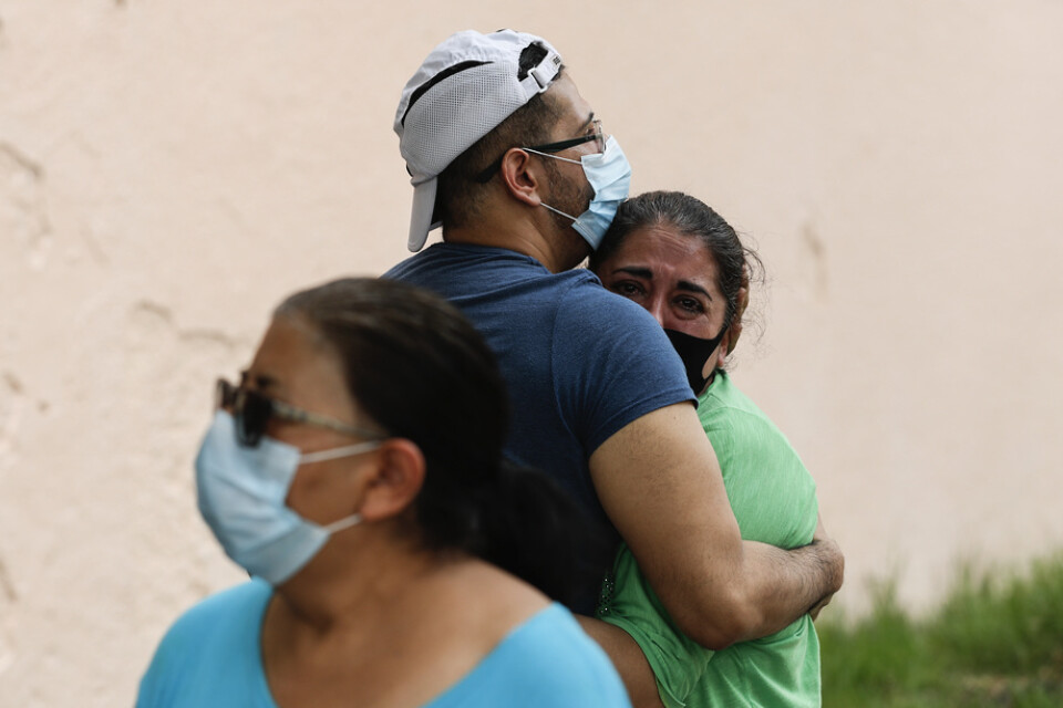 Människor omfamnar varandra i väntan på att kunna återvända till sina lägenheter efter jordskalvet i Mexiko den 23 juni.