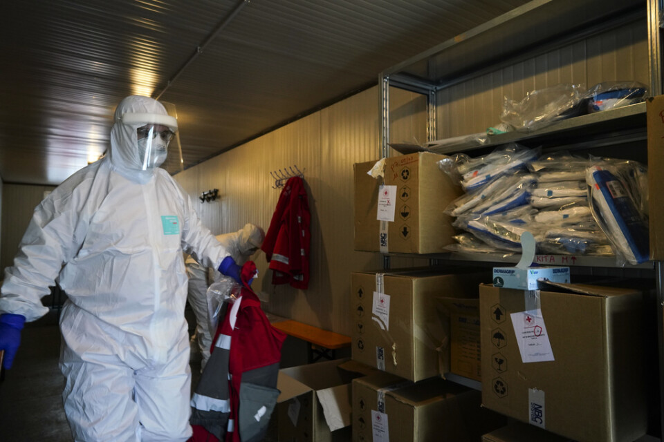 Sjukvårdspersonal från Röda Korset förbereder transporten av en patient som smittats av coronaviruset i Italiens huvudstad Rom på fredagen.
