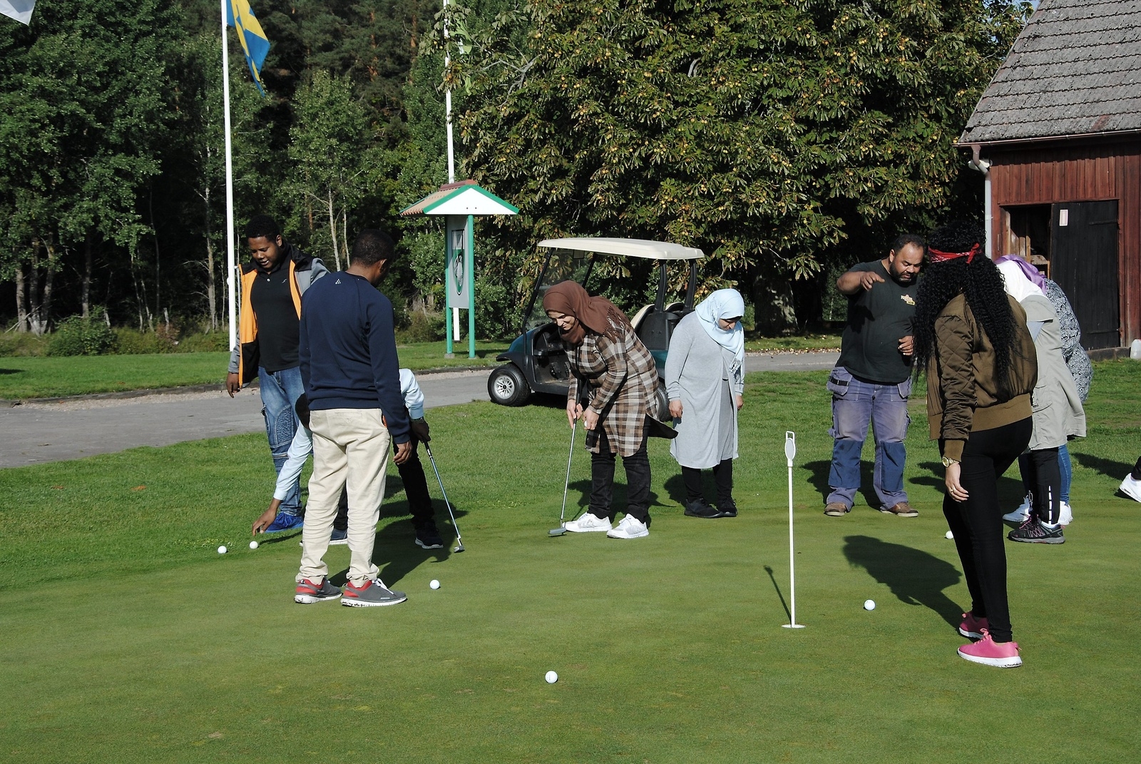 Den här onsdagen var en SFI-klass på golfbanan med sin lärare.