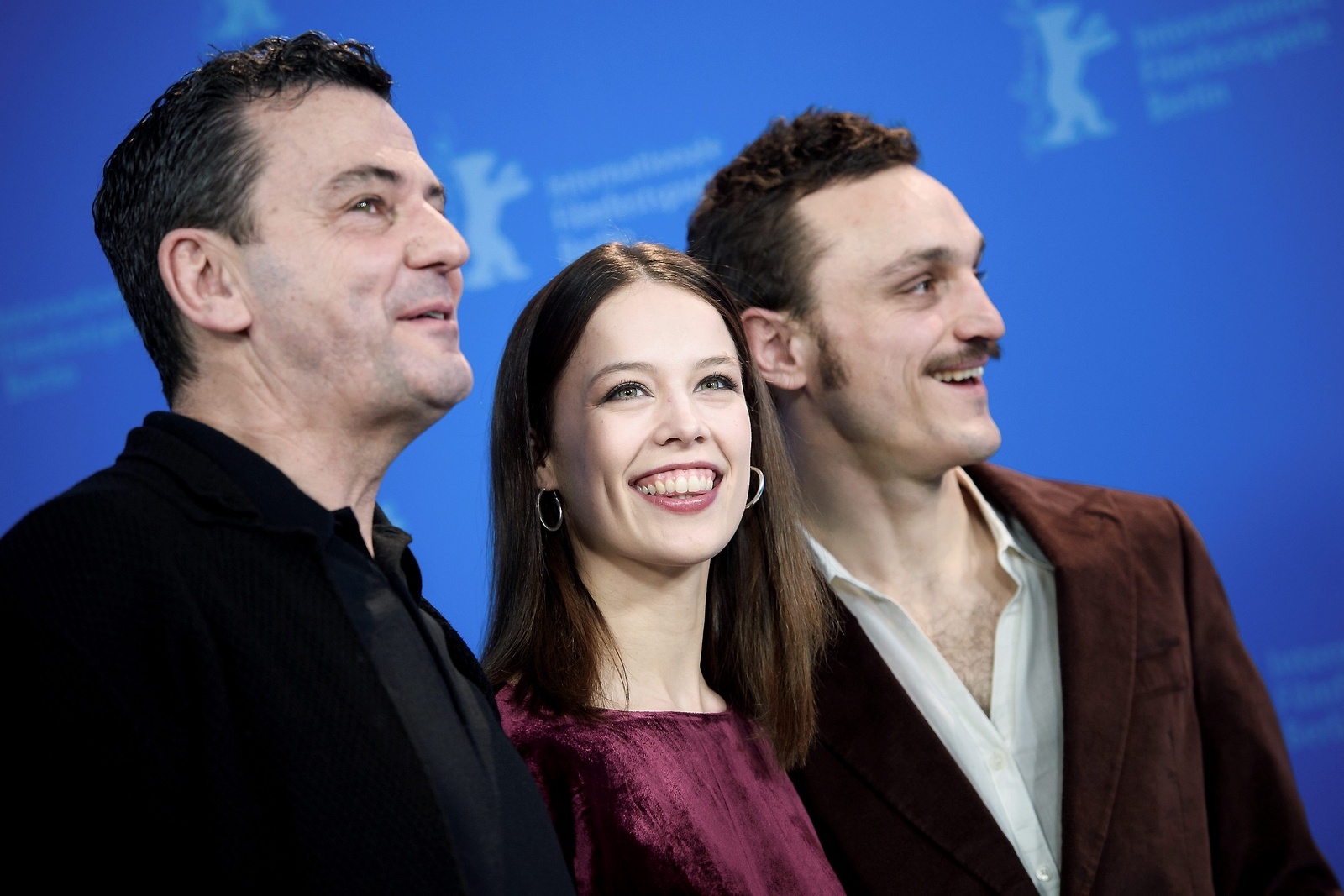 Director Christian Petzold, left, actress Paula Beer, center, and actor Franz Rogowski, right, pose during a photo-call for the film Undine at the 70th International Film Festival Berlin, Berlinale in Berlin, Germany, Sunday, Feb. 23, 2020. (Gregor Fischer/dpa via AP)  DMSC126