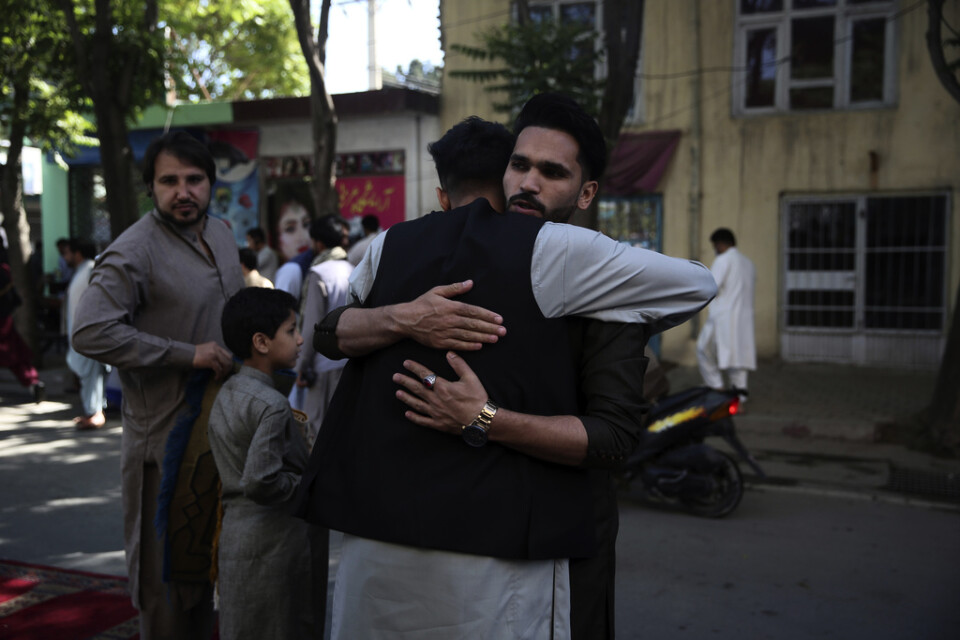 Två män kramar om varandra efter böner i samband med id al-fitr utanför en moské i Afghanistans huvudstad Kabul i söndags.