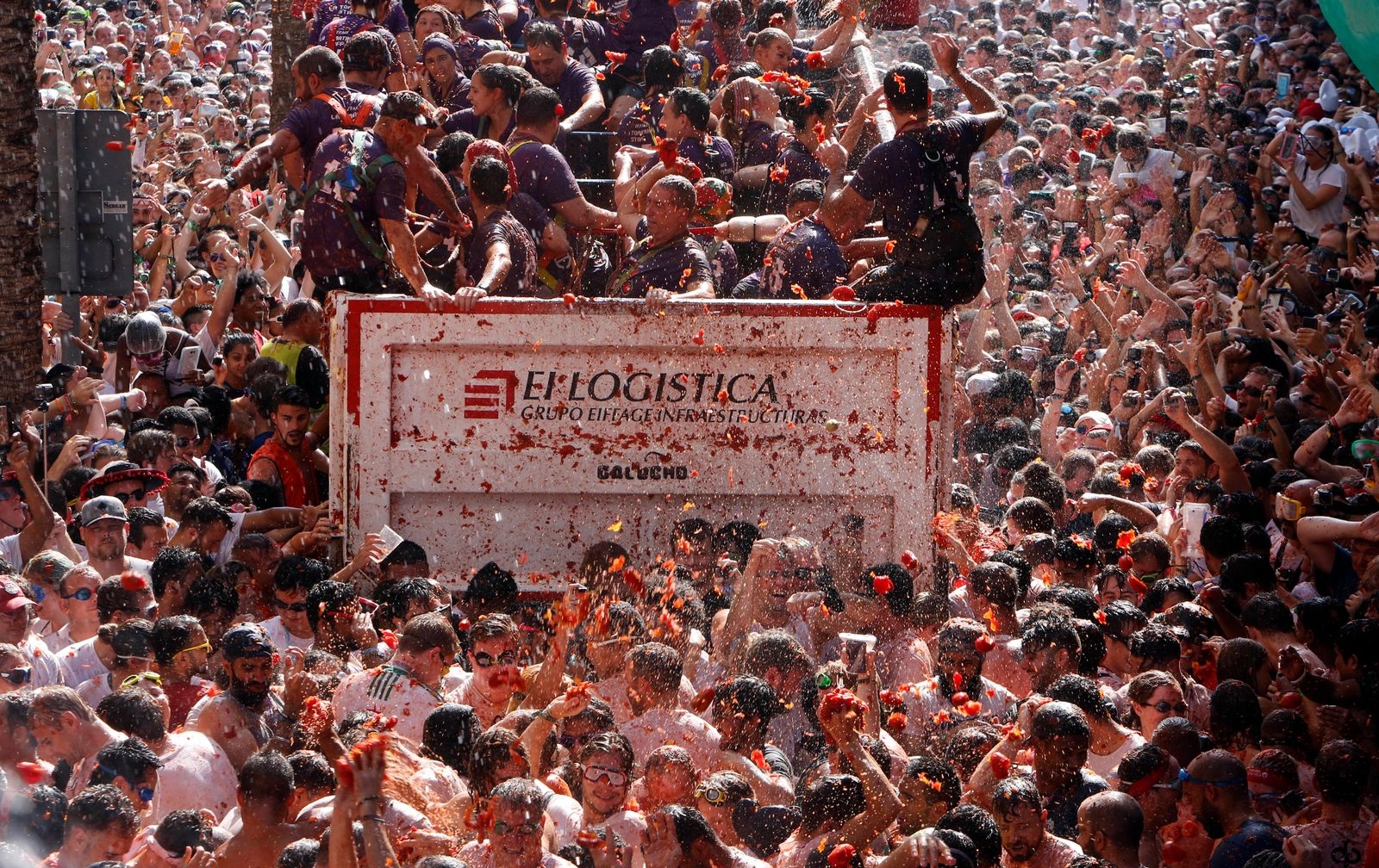 Revelers throw tomatoes at each other, during the annual "Tomatina", tomato fight fiesta, in the village of Bunol, 50 kilometers outside Valencia, Spain, Wednesday, Aug. 29, 2018. At the annual "Tomatina" battle, that has become a major tourist attraction, trucks dumped 160 tons of tomatoes for some 20,000 participants, many from abroad, to throw during the hour-long Wednesday morning festivities. (AP Photo/Alberto Saiz)