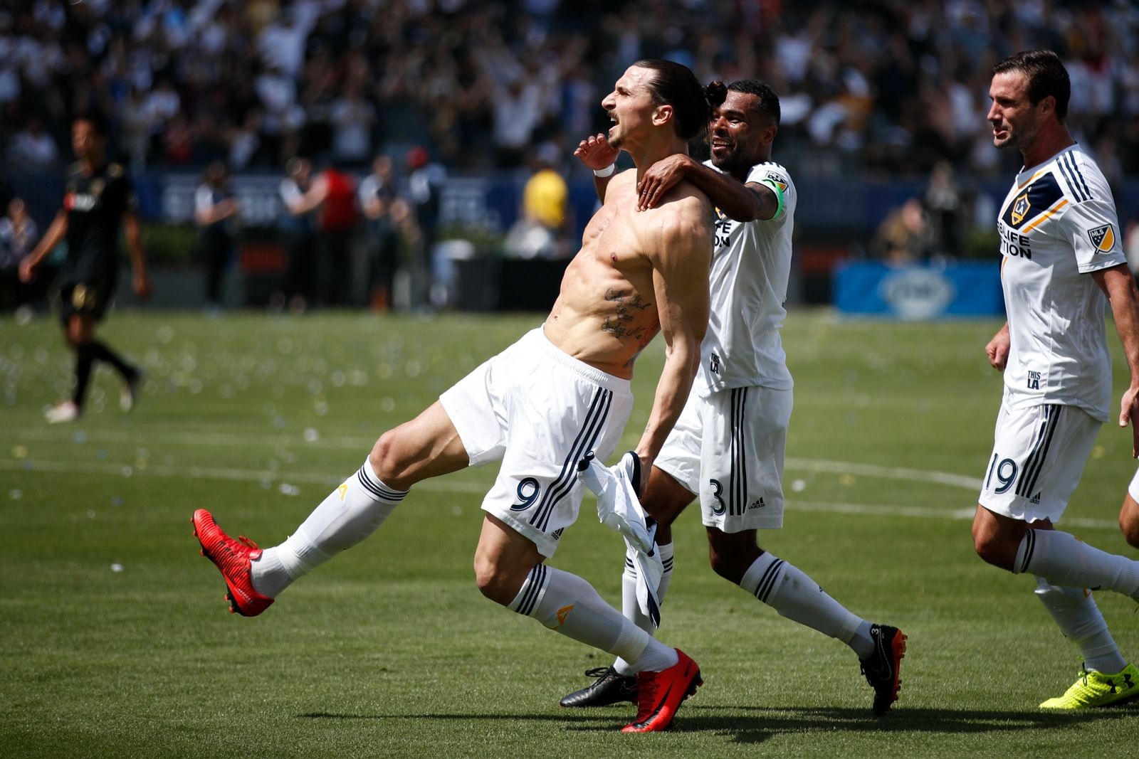 Los Angeles Galaxy's Zlatan Ibrahimovic, left, of Sweden, celebrates his debut goal with Ashley Cole and Chris Pontius, right, during the second half of an MLS soccer match against the Los Angeles FC Saturday, March 31, 2018, in Carson, Calif. The Galaxy won 4-3. (AP Photo/Jae C. Hong)