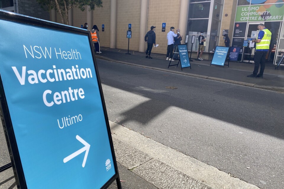 Människor köar för att få sitt covidvaccin i centrala Sydney.