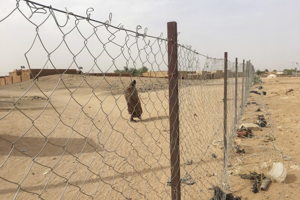 Ett kvínna står utanför ett dammigt flygfält i Niger, där oroligheterna trappats upp sedan presidentvalet i slutet av december. Arkivbild.